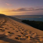 dune du pilat coucher de soleil, vue dorée sur l’océan Atlantique